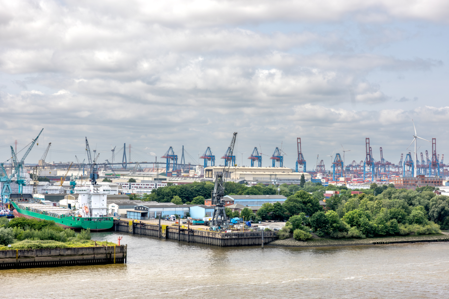 Port cranes. Cargo ship. Industrial skyline.